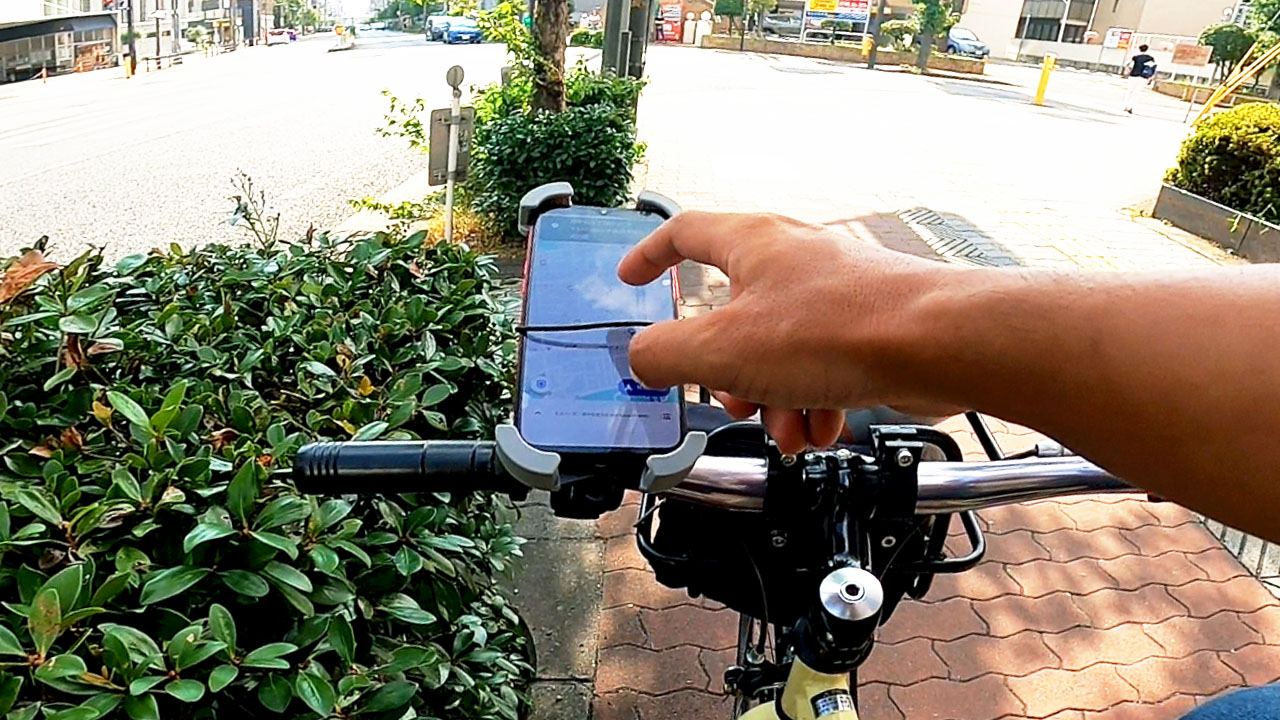 Smartphone mounted on bicycle handlebars using a secure bike mount for hands-free navigation