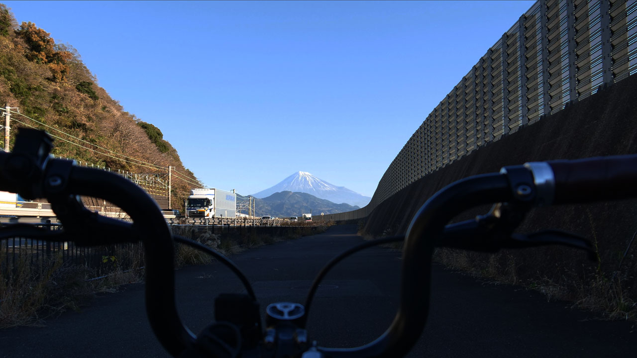 Cyclist on National Route 1 highway between Osaka and Tokyo - typical Cannonball route scenery