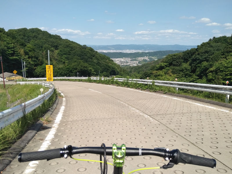 A view of the city basin far below from a steep mountain road