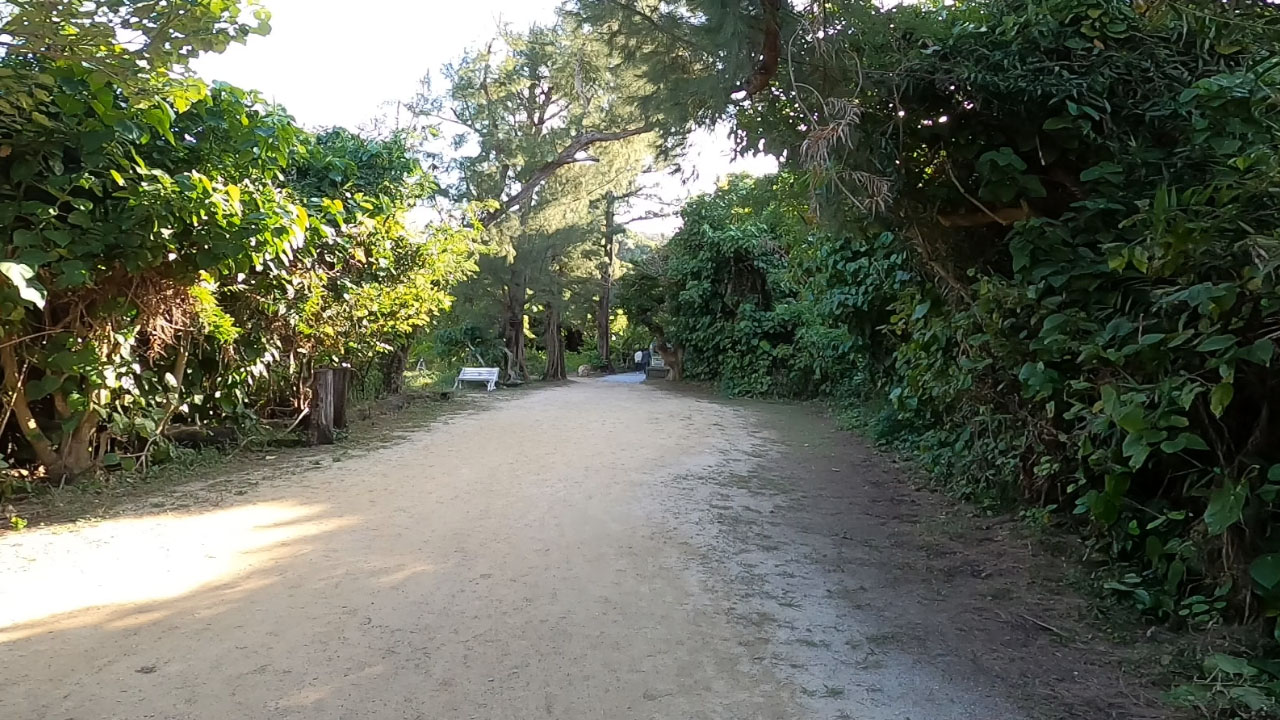 Silmitchu shrine - ancient stone monument with moss-covered rocks and traditional Ryukyuan design at Hama-Higa Island's southern tip