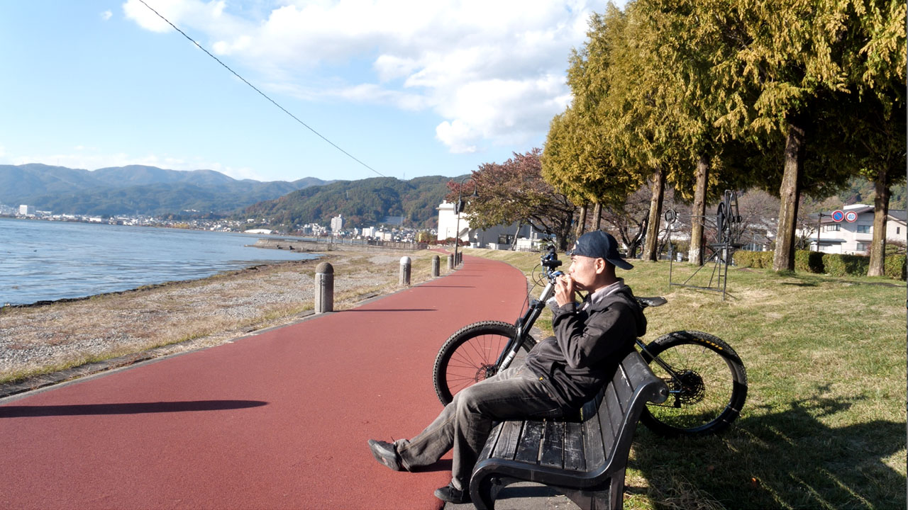 Suwa Lake cycling path - scenic lake view with mountains in background