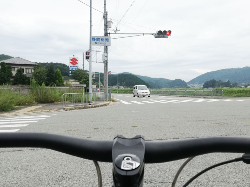 Diagram showing two-stage right turn procedure at Japanese intersection - go straight, wait, then turn right