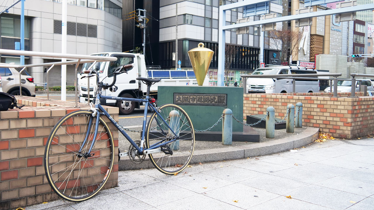 Umeda Shindō Intersection road marker - golden object on right side is the Route 1 starting point marker