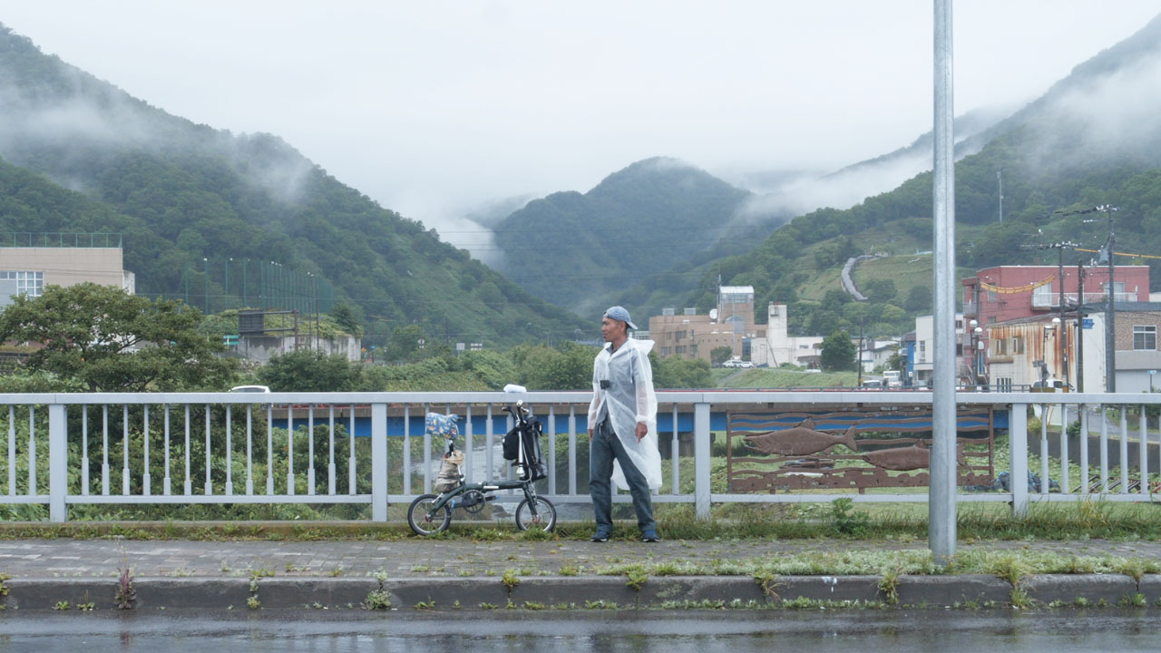 Cyclist riding in rain - demonstrating weather independence mindset